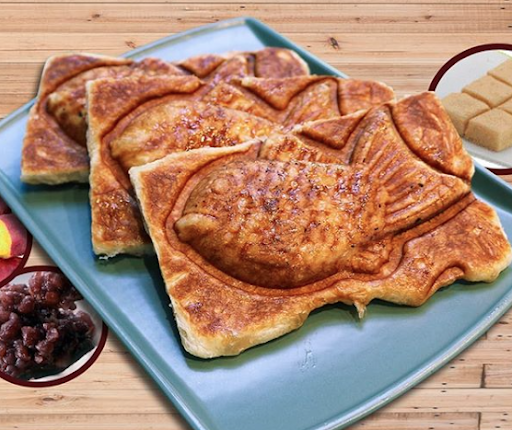 Three taiyaki that look fresh and like they haven't even been cut out yet.