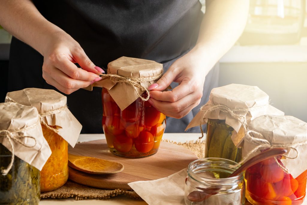 Salting, or curing, an assortment of vegetables in jars