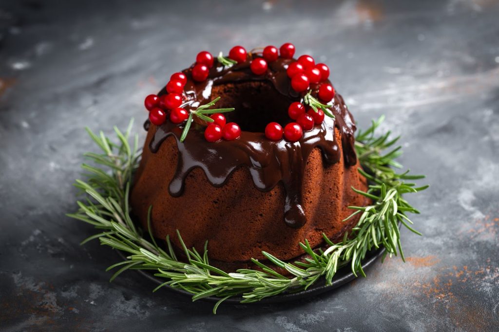 A classically decorated Bundt cake with glaze and fruits