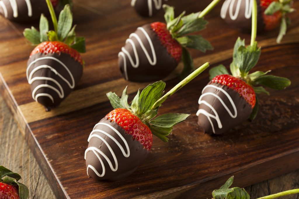 A few strawberries dipped in dark chocolate with a drizzle of white chocolate on top