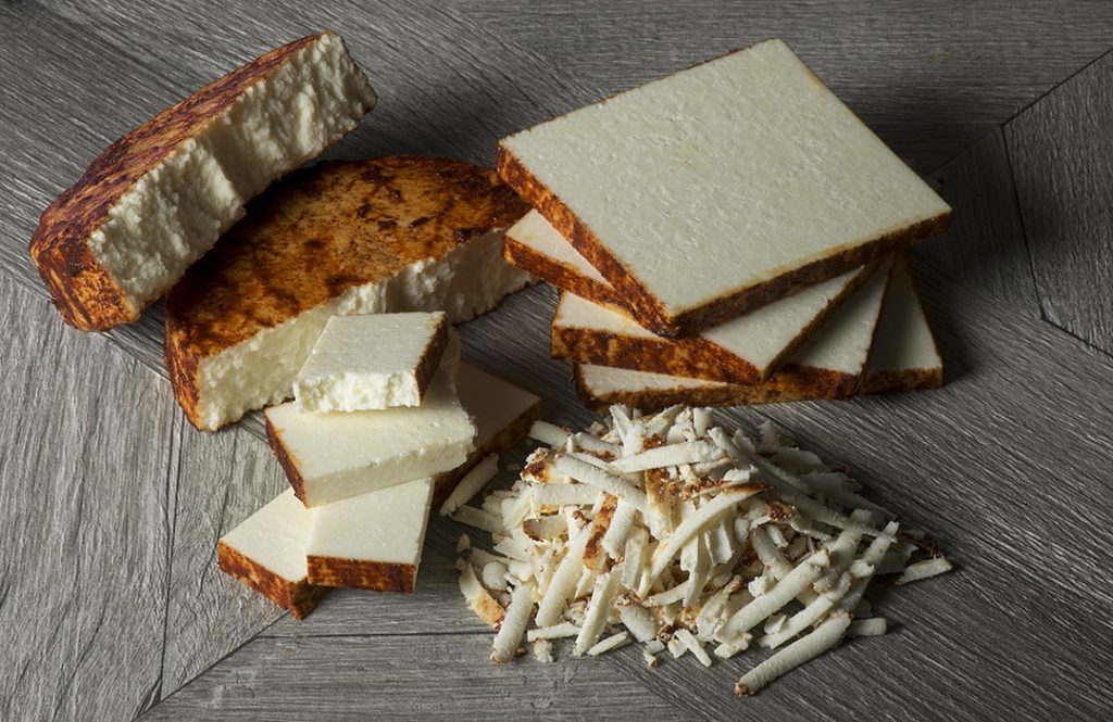 Powdered Anejo cheese sliced and shredded into different shapes and size.