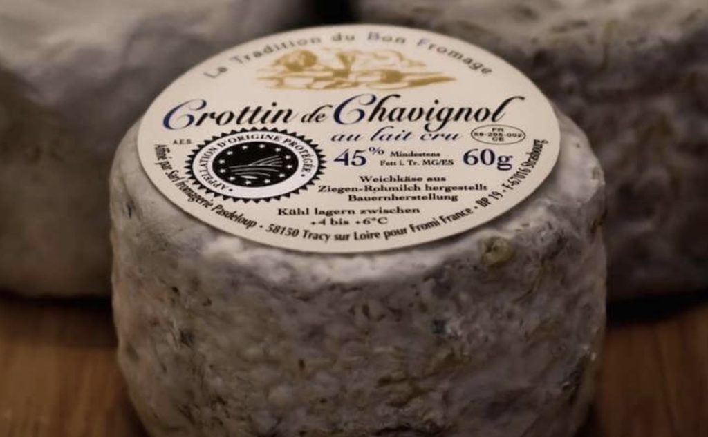 A wheel of Crottin de Chavignol still in its packaging.