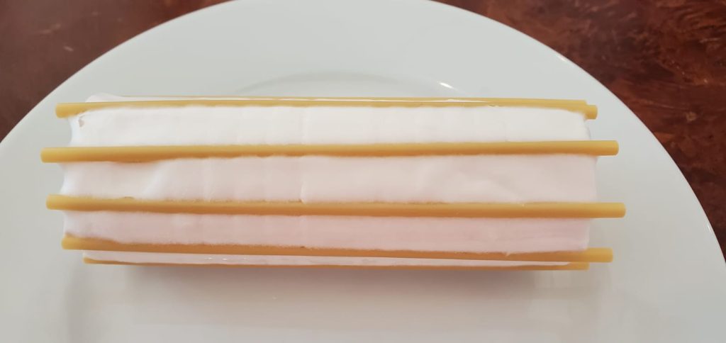 A cylindrical Paillot de Chèvre with about 8 sticks running lengthwise.