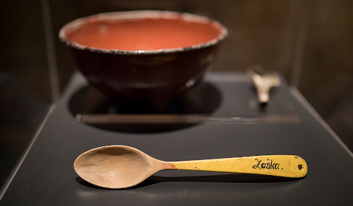 A bowl and wooden spoon given to those sent to the Auschwitz Birkenau