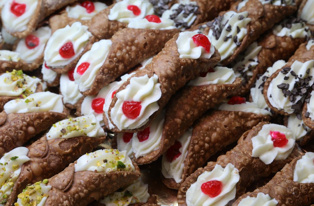 Sicilian Cannoli with traditional fillings topped with candied fruit, chocolate chips and pistachio